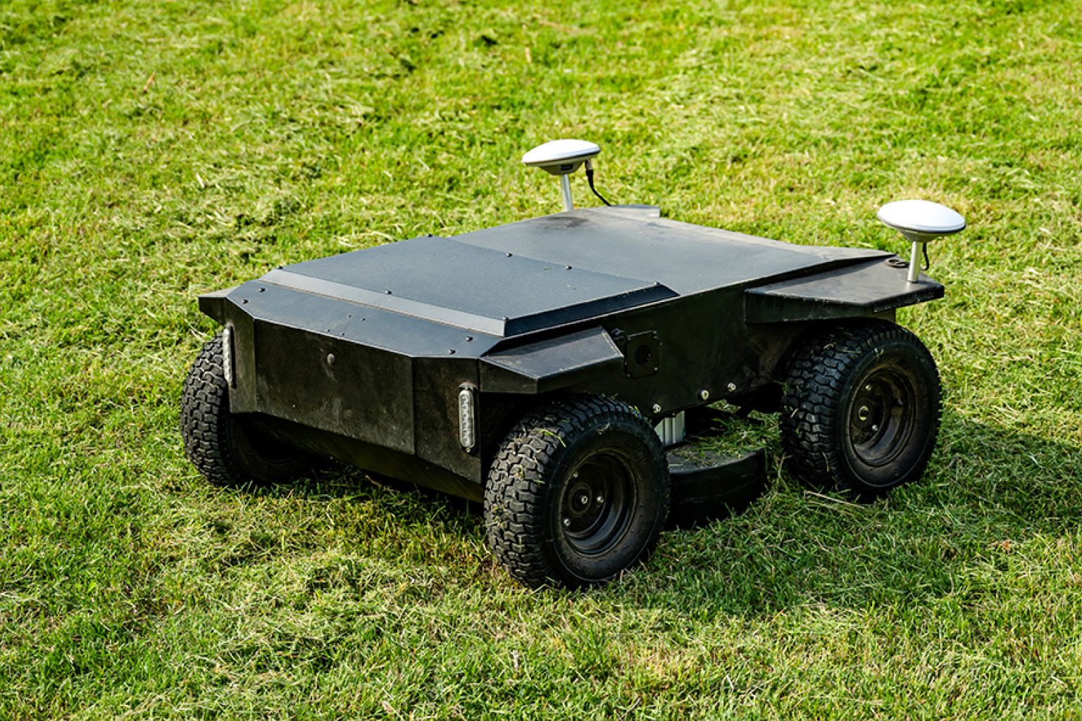 Kelpie autonomous electric mower on mown grass
