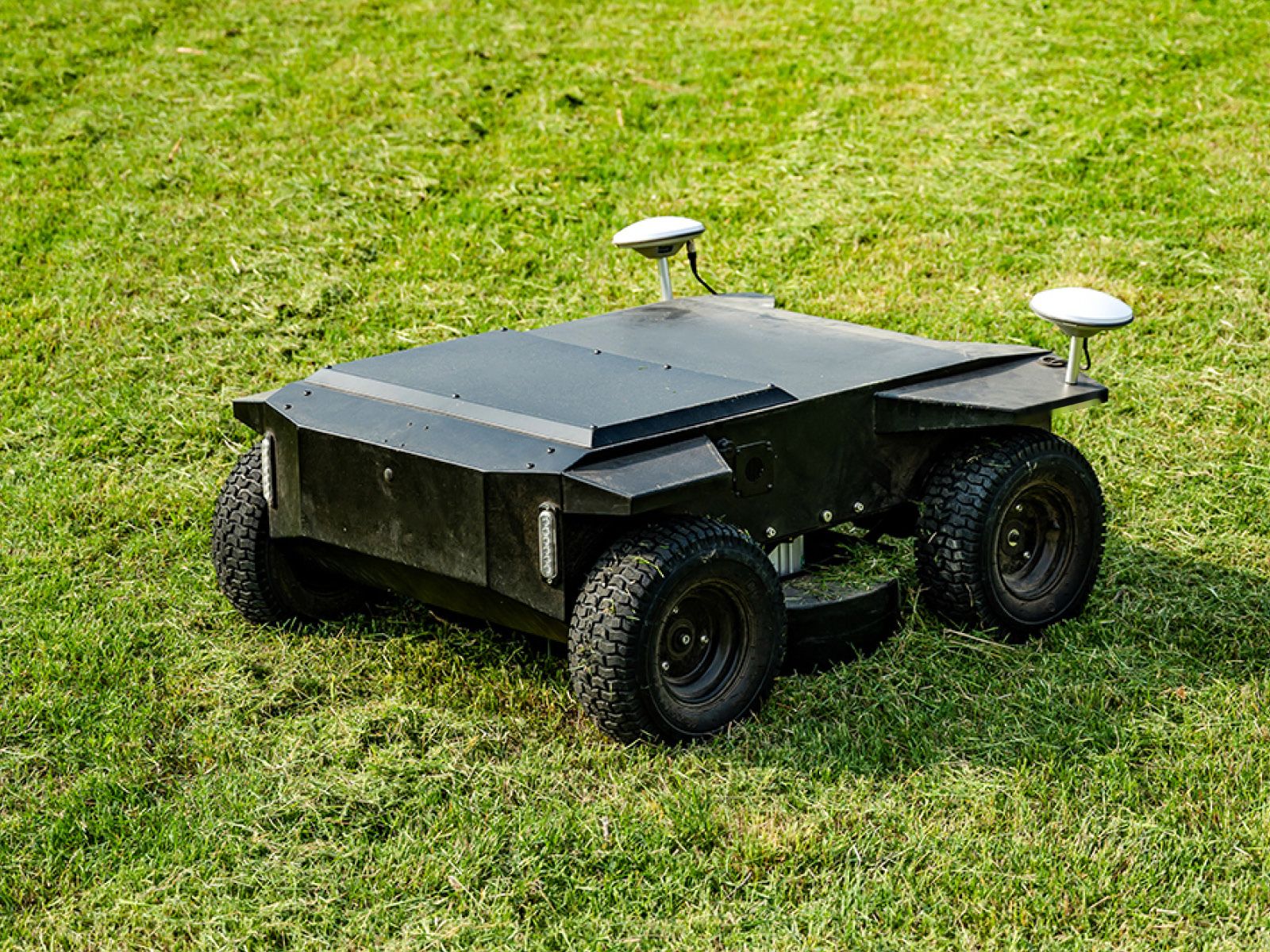 Kelpie autonomous electric mower on mown grass